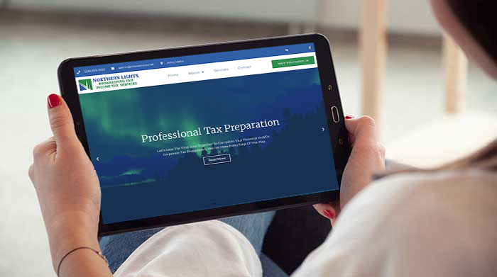 Photo of table with Northern Lights Tax Services' website on the screen.